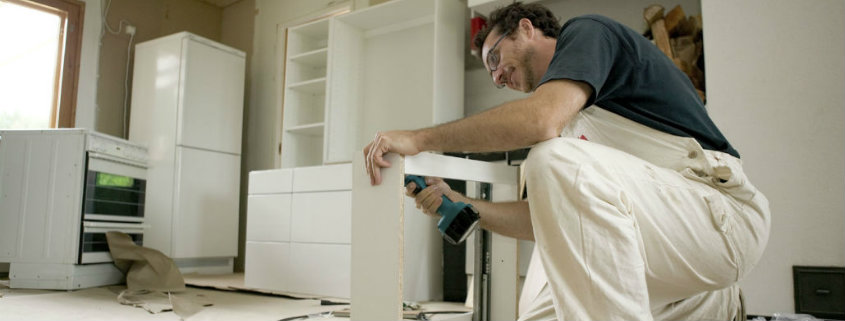 man hard at work on kitchen cabinet replacement spring tx